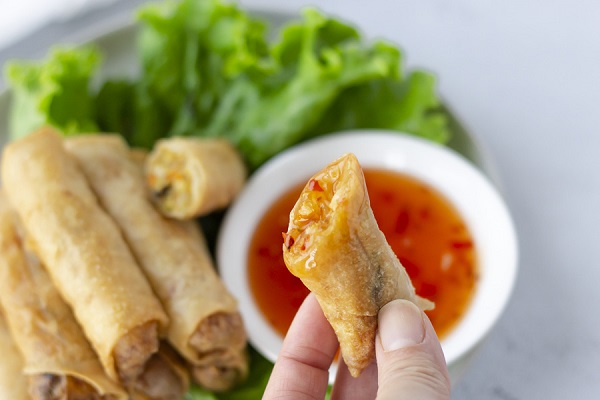 dipping spring roll on sauce
