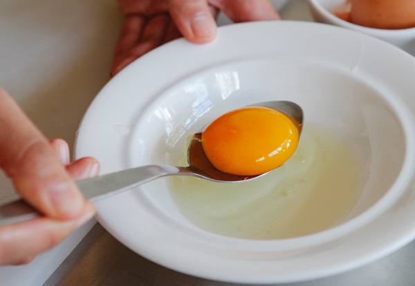 egg yolk on a spoon