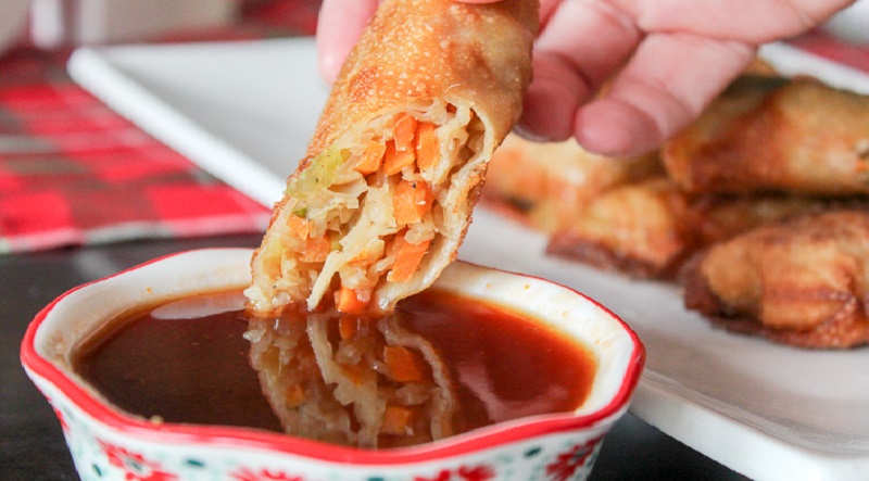 dipping Egg Roll on Sauce